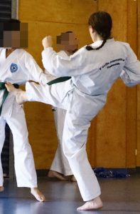 2 female students sparring at a Taekwondo grading