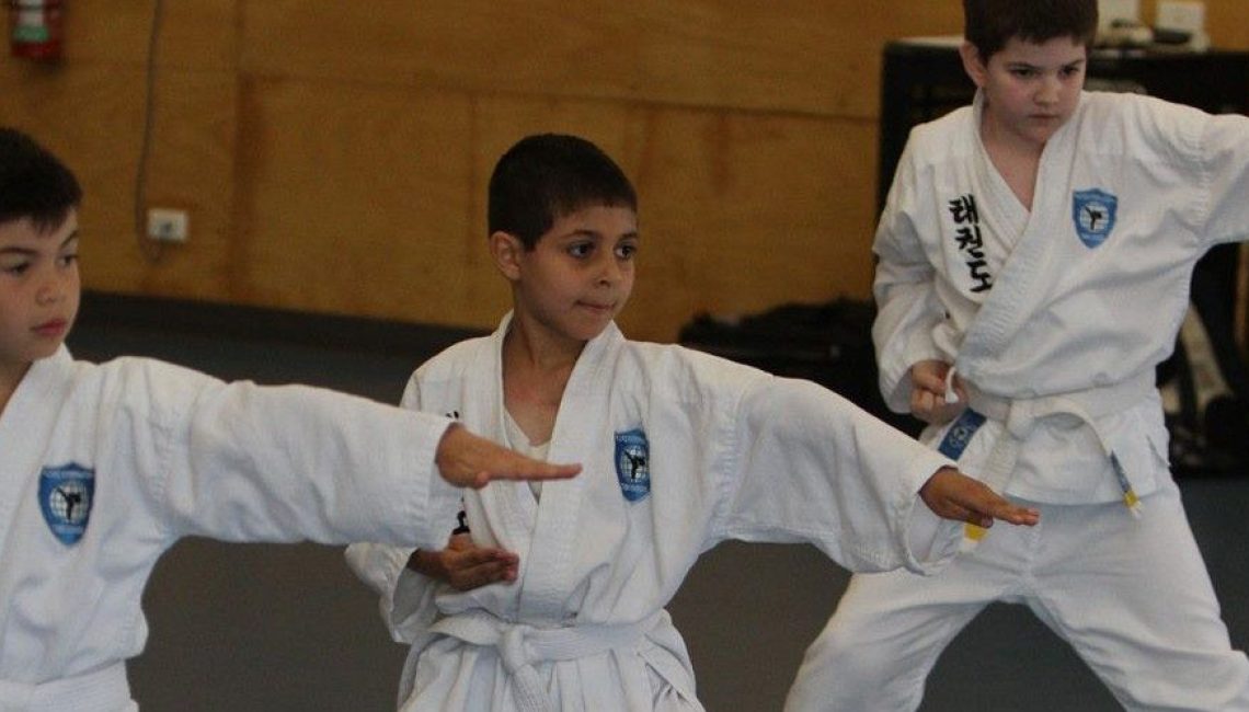 pacific taekwondo three boys stand firm