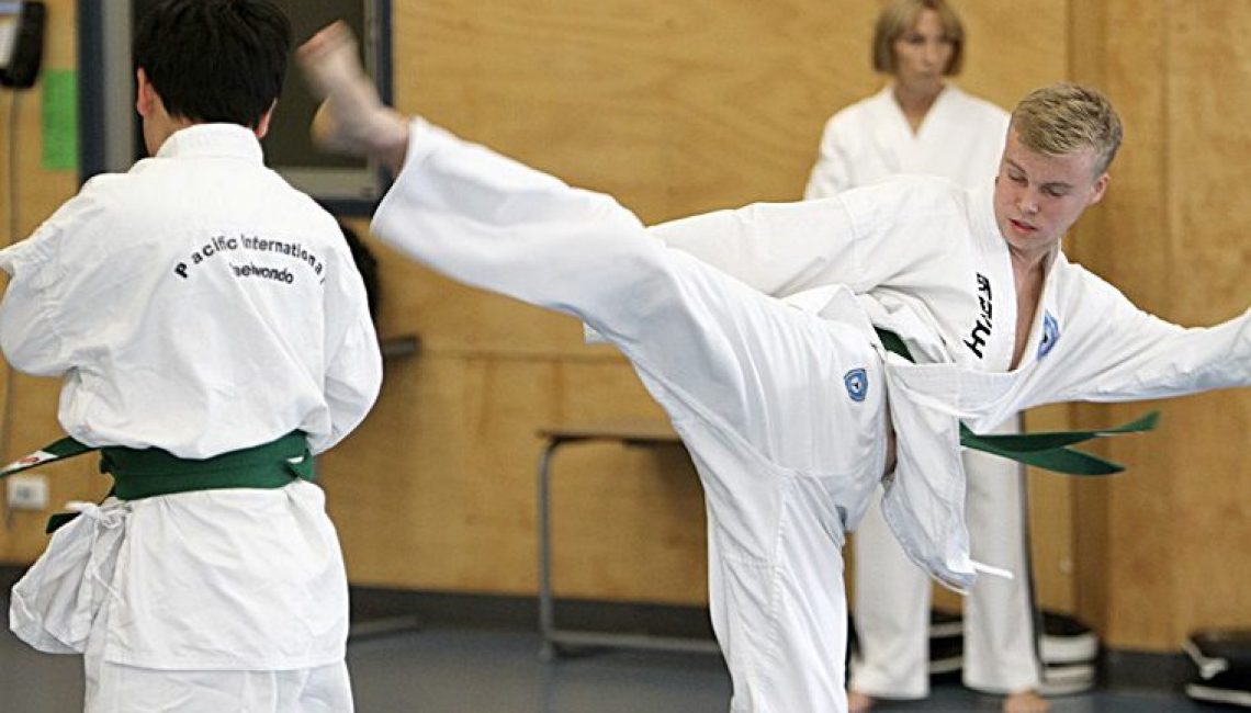 Taekwondo class, teens sparring