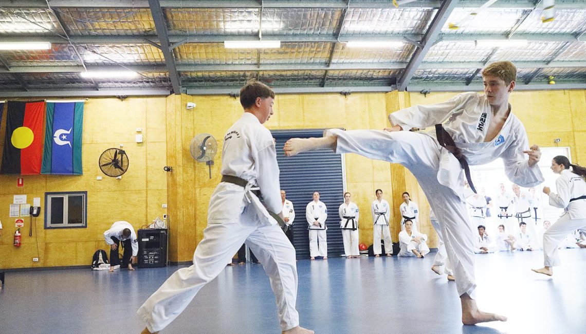 teen males taekwondo sparring