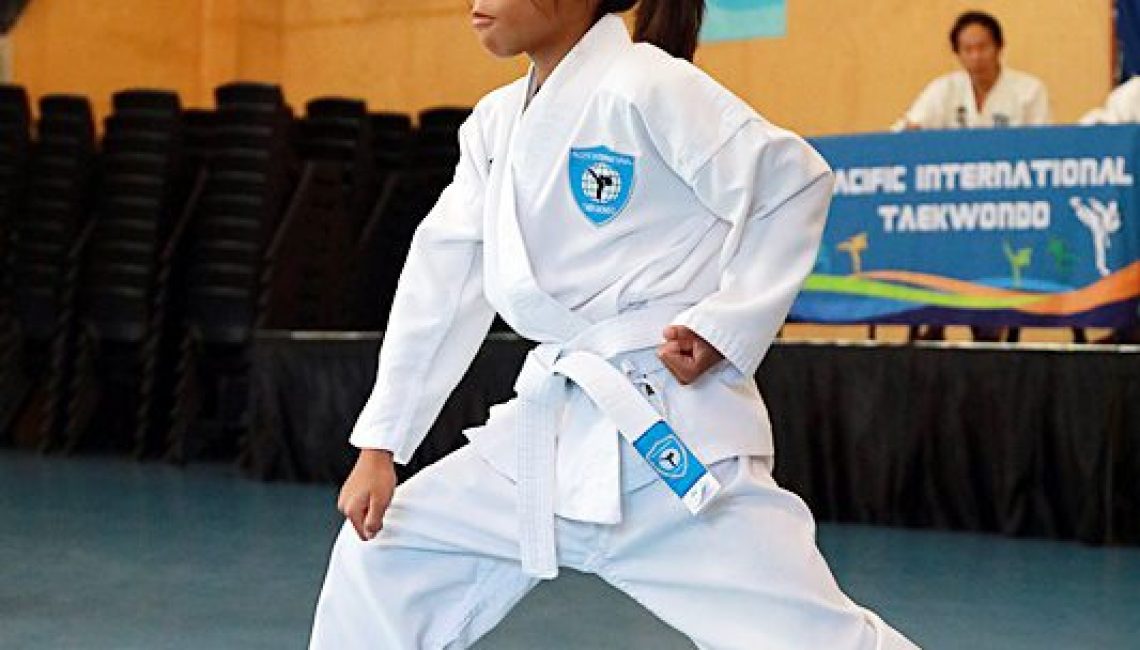 young girl takes defensive taekwondo stance